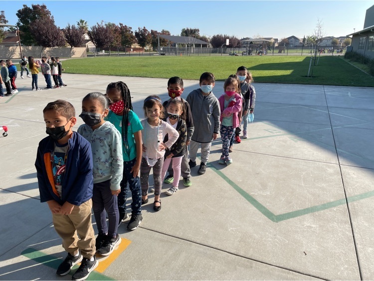 Kinder students standing in line at recess. 