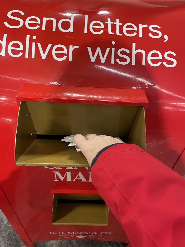 Letters being put in Santa's mailbox